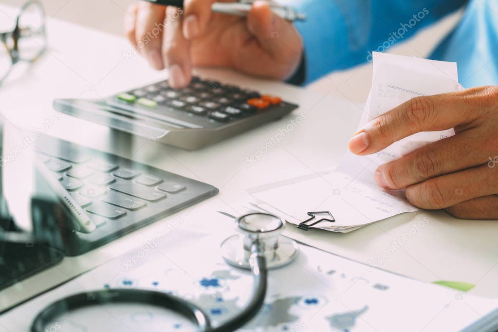 Healthcare costs and fees concept.Hand of smart doctor used a ca