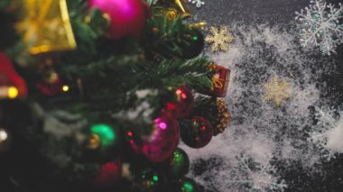 Tebrik sezon kavramı. Noel ağacı ve süslemeleri ile el ayarı sunar ve masada beyaz tahta yukarıdan yağan kar 4 k (Uhd süsler)