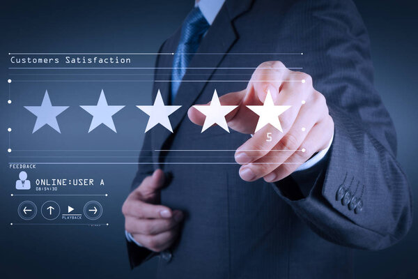 Five stars (5) rating with a businessman is touching virtual computer screen.For positive customer feedback and review with excellent performance.