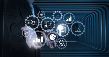 İş verilerini analytics yönetimi KPI mali çizelgeleri ile bağlı dişli çarkları ve graph.business adam bir şeyler gösteriyor olarak açık bir el ile kavramı