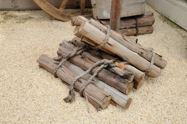 Stack of firewood on small rock — Stock Photo, Image