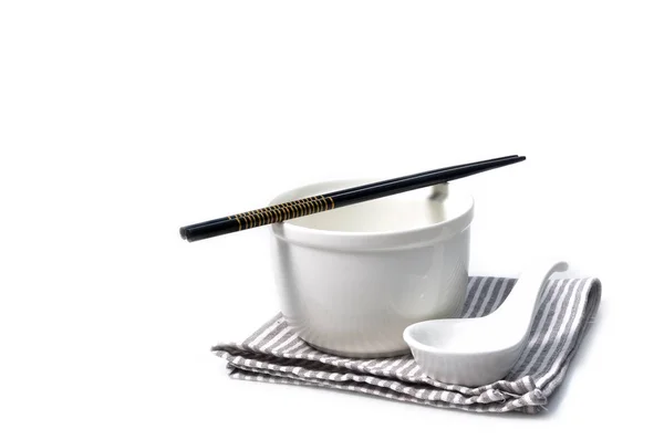 Ceramic bowl and spoon with chopsticks on gray strip napkin — Stock Photo, Image