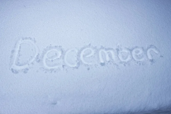 December handwritten on fresh snow. — Stock Photo, Image