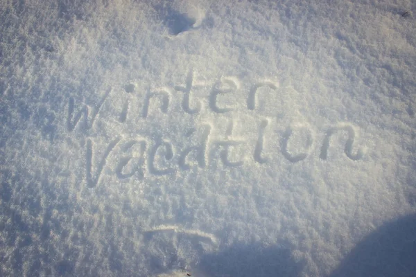 Vacaciones de invierno escritas a mano sobre nieve fresca . — Foto de Stock