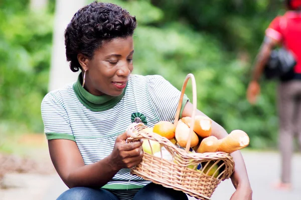 CASİYE genç kadın onun uyluk bir gıda sepeti tutar.