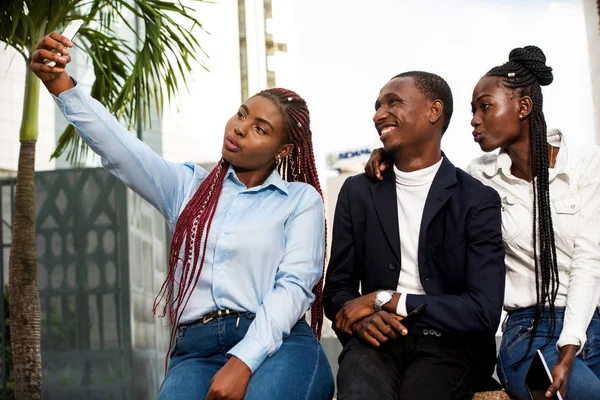 Group of business people in formal attire taking a photo with ph — Stock Photo, Image