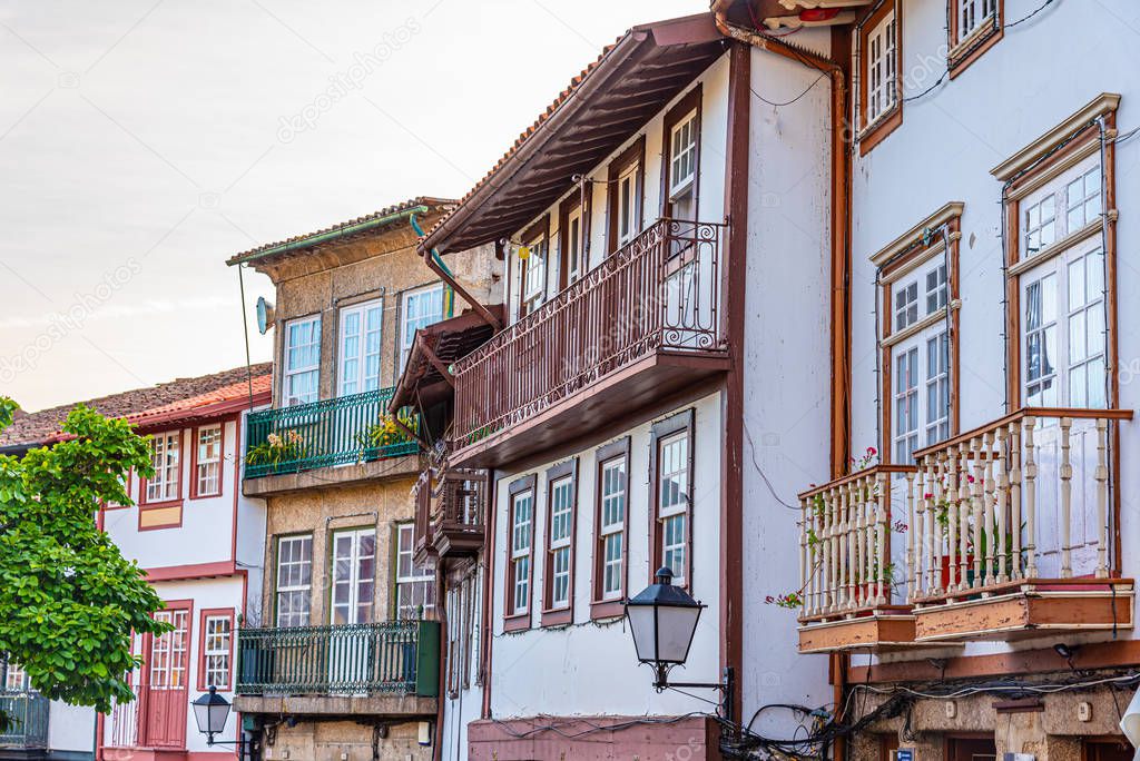 Facades of houses at Praca de Sao Tiago in the old town of Guima