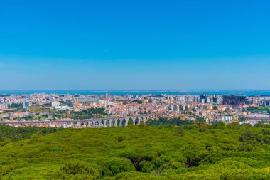 Aerial view of Lisbon dominated by an ancient aqueduct, Portugal clipart