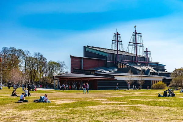 STOCKHOLM, SWEDEN, APRIL 20, 2019: People are laying on lawn in Royalty Free Stock Photos