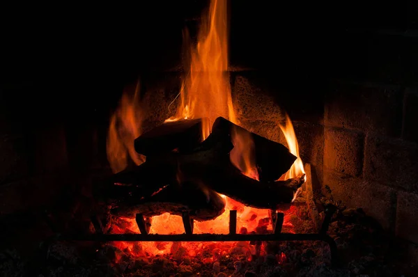 Fireplace lit and vigorous flames rise