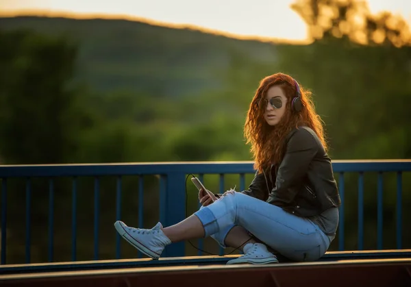 Red-haired girl with phone — Stock Photo, Image