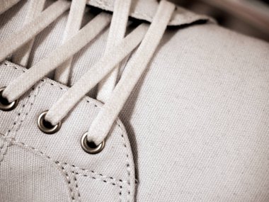 Shoelace and grommets of white sneaker, close up. clipart