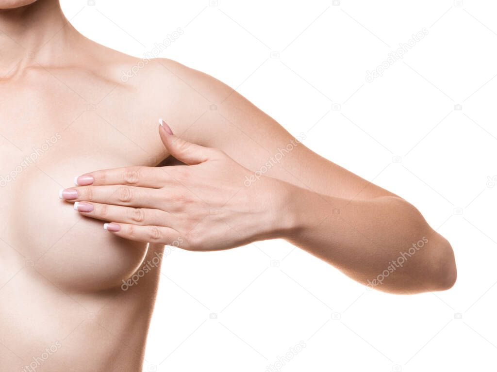 Caucasian woman cover her new breast with hand, closeup. Female upper body without face, isolated on white.