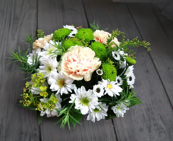 Bouquet from green and white chrysanthemums in a basket