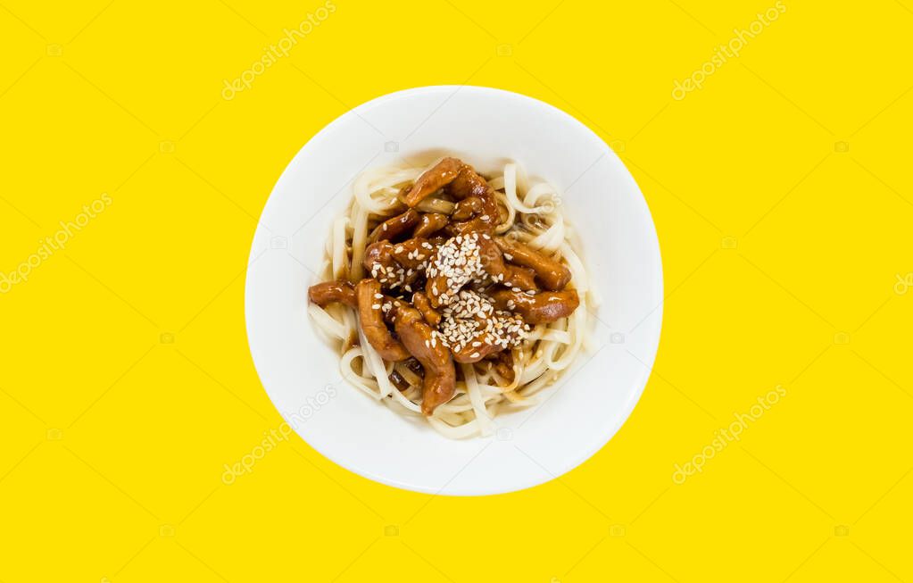 Noodles with sliced pork and sesame seeds; yellow background