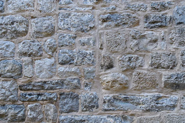 Fragmento Uma Antiga Parede Pedra Feita Pedras Ásperas Contexto Cinza — Fotografia de Stock