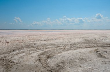 Güneşli bir günde kurumuş tuz gölü ve güzel bir gökyüzü.
