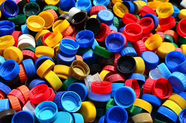 Plastic bottle caps background. Cap material is recyclable.Remove lids from plastic bottles before recycling them. Recycling collection and processing plastic bottle caps