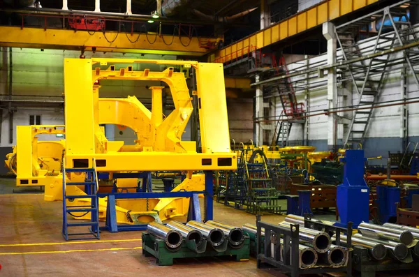 Production process of heavy mining trucks at the factory. Dump truck on the Industrial conveyor in the workshop of an automobile plant. Manufacturer of haulage and earthmoving equipment, haul trucks