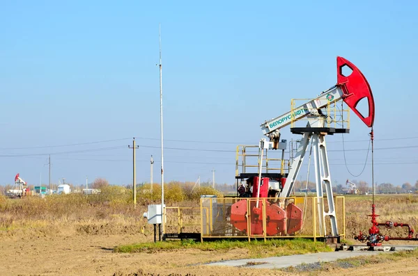 Oil drilling derricks at desert oilfield for fossil fuels output and crude oil production from the ground. Oil drill rig and pump jack.