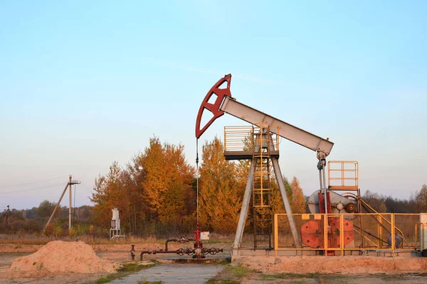 Oil drilling derricks at desert oilfield for fossil fuels output and crude oil production from the ground. Oil drill rig and pump jack.