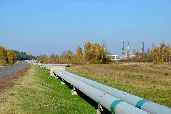 Natural Gas Pipelines network. Gas Processing Plant in Belarus, Rechitsa, Gomel region. Pipe and industrial refinery towers of the natural gas factory on the background blue sky. Oil equipment