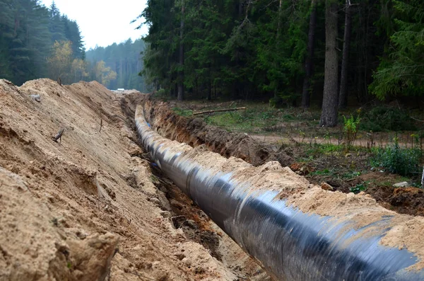 Natural gas pipeline construction work. A dug trench in the ground for the installation and installation of industrial gas and oil pipes. Underground work project
