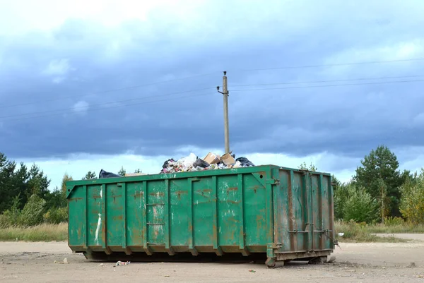 Skip for dumping renovation waste. Metal tanks and capacities for storage and transportation of garbage. Metal trash cans and containers for MSW.
