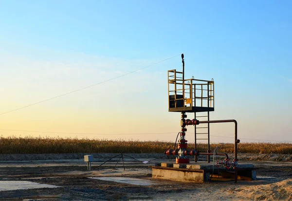 Oil drilling derricks at desert oilfield for fossil fuels output and crude oil production from the ground. Oil drill rig and pump jack.