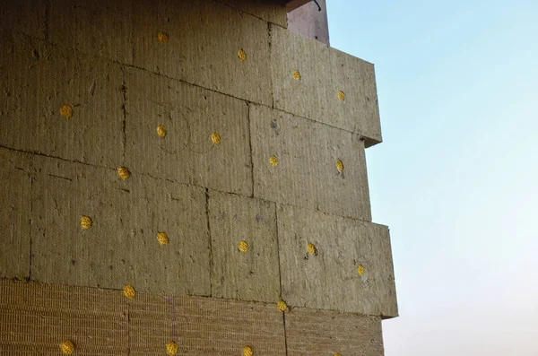 Mineral wool insulation of the facade building on construction site.  Background, texture,  small  sharpness.