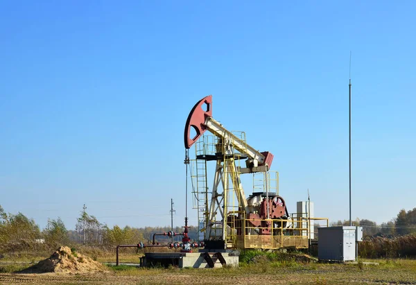 Oil drilling derricks at desert oilfield for fossil fuels output and crude oil production from the ground. Oil drill rig and pump jack.