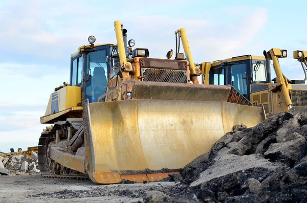 Track-type bulldozer, earth-moving equipment. Land clearing, grading, pool excavation, utility trenching, utility trenching and foundation digging during of large construction jobs.