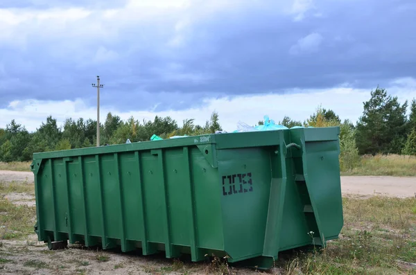 Skip for dumping renovation waste. Metal tanks and capacities for storage and transportation of garbage. Metal trash cans and containers for MSW.