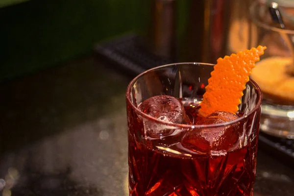 Classic Boulevardier cocktail with fine orange zest garnish; could be used for a menu or text on the side