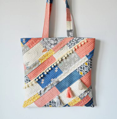 Quilted boho tote bag over white