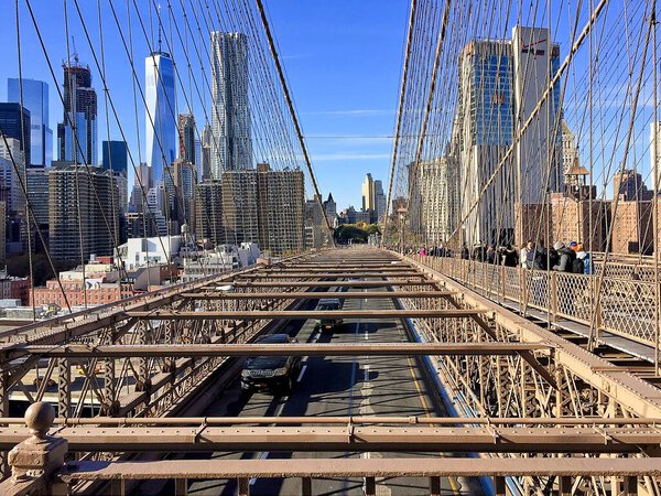 NEW YORK, USA - NOVEMBER 12, 2016: Manhattan skyline trough Brooklyn bridge