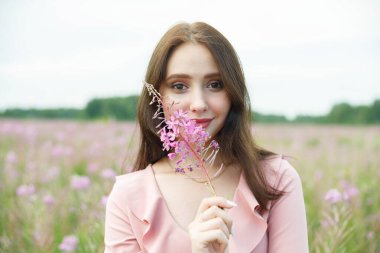 Leylak çiçekli bir tarlada güzel bir kız.