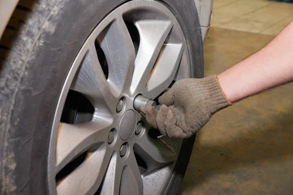 The process of changing tires on a car before the season.