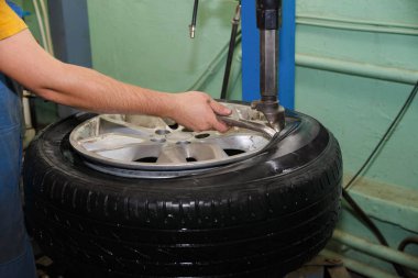 Üstat arabaların lastiklerini çıkarıyor.