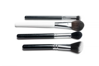 Makyaj fırçaları beyaz arka planda izole edilmiş. Profesyonel makyaj fırçaları. Doğal ve sentetik kıllar, siyah saplar ve zarif görünümlü makyaj aletleri..