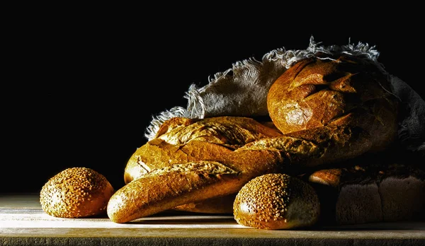 Bread on a black background. — Stock Photo, Image