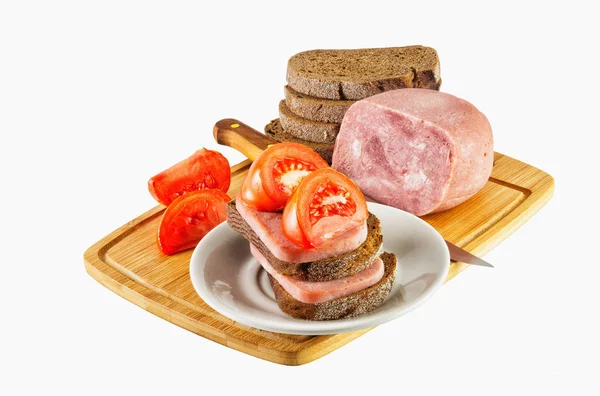 Ham and tomatoes lying on the plate and insulated background — Stock Photo, Image