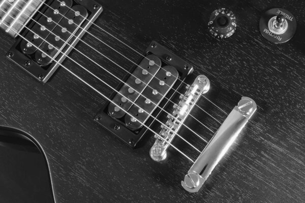 Poster, electric guitar, steel bridge, silver strings, black case