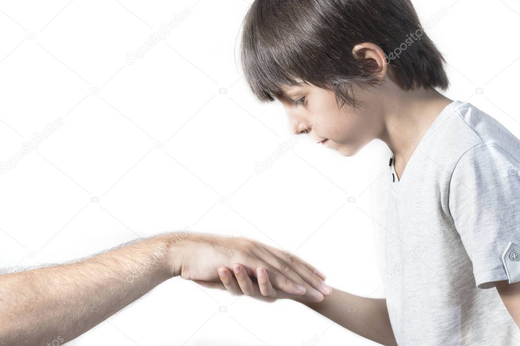 Kid kissing parent's hand