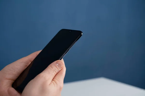 Young woman using apps on a mobile touchscreen smartphone. Concept for using technology, shopping online, mobile apps, texting, addiction, videocall, swipe. Work at home.