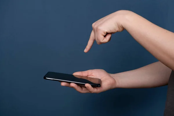 Young woman using apps on a mobile touchscreen smartphone. Concept for using technology, shopping online, mobile apps, texting, addiction, videocall, swipe.