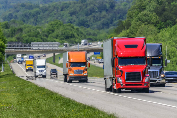 A steady flow of semis lead the way down a busy interstate highway in east Tennessee