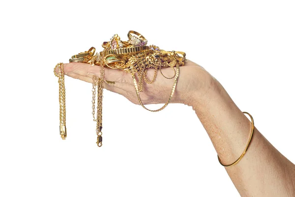 Mão segurando jóias de ouro — Fotografia de Stock