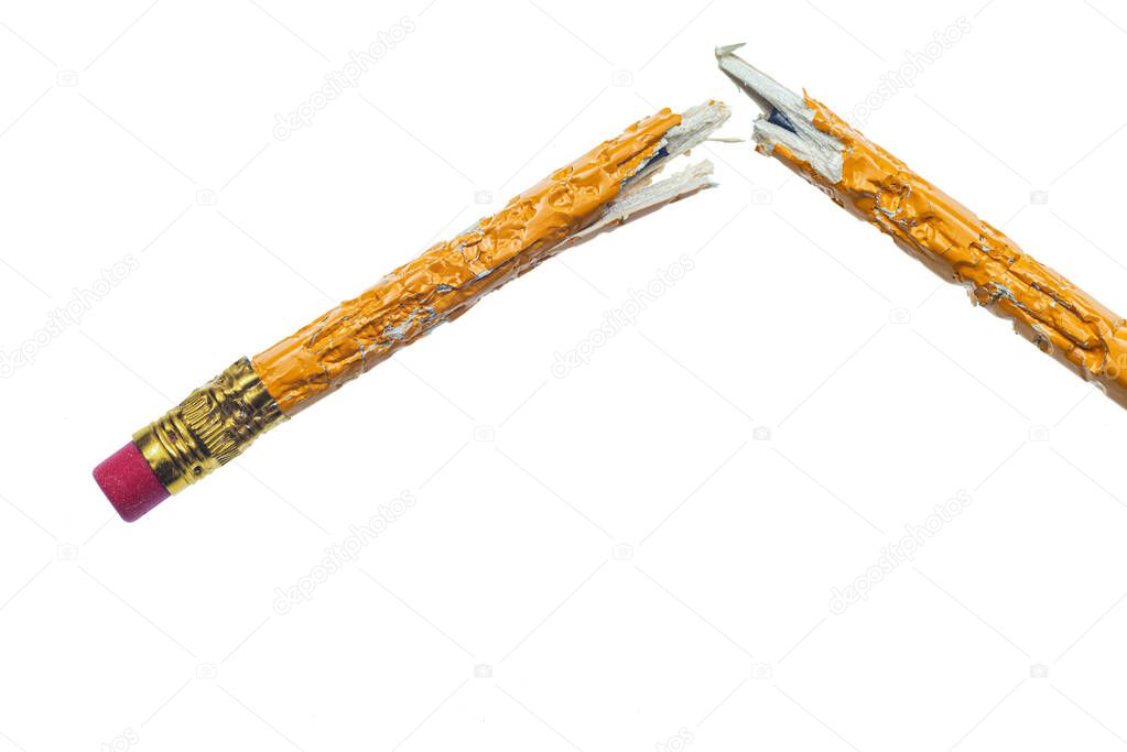 Horizontal shot of a chewed and broken pencil on a white background.  Copy Space.