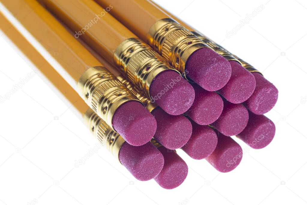 Horizontal close-up shot of the eraser ends of a group of pencils.  They facing toward the camera.  White background.